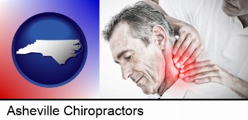 male chiropractor massaging the neck of a patient in Asheville, NC
