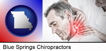 male chiropractor massaging the neck of a patient in Blue Springs, MO