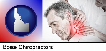 male chiropractor massaging the neck of a patient in Boise, ID