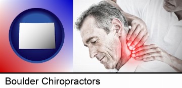 male chiropractor massaging the neck of a patient in Boulder, CO