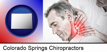 male chiropractor massaging the neck of a patient in Colorado Springs, CO