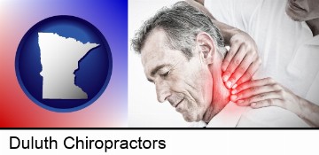 male chiropractor massaging the neck of a patient in Duluth, MN