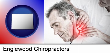 male chiropractor massaging the neck of a patient in Englewood, CO