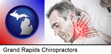 male chiropractor massaging the neck of a patient in Grand Rapids, MI
