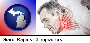 Grand Rapids, Michigan - male chiropractor massaging the neck of a patient