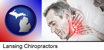 male chiropractor massaging the neck of a patient in Lansing, MI