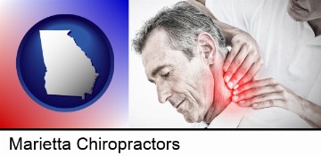 male chiropractor massaging the neck of a patient in Marietta, GA