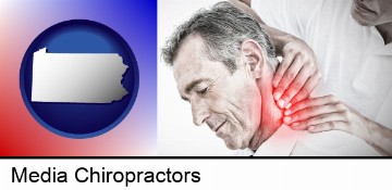 male chiropractor massaging the neck of a patient in Media, PA