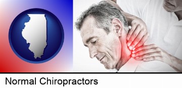 male chiropractor massaging the neck of a patient in Normal, IL