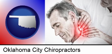 male chiropractor massaging the neck of a patient in Oklahoma City, OK
