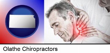 male chiropractor massaging the neck of a patient in Olathe, KS