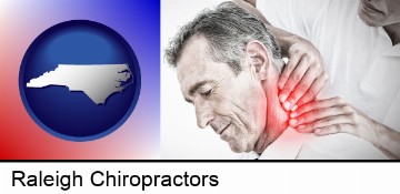 male chiropractor massaging the neck of a patient in Raleigh, NC