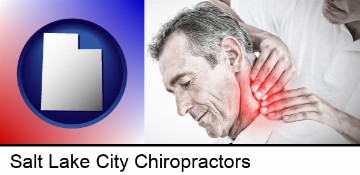 male chiropractor massaging the neck of a patient in Salt Lake City, UT