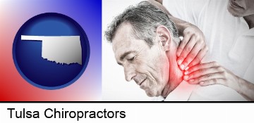 male chiropractor massaging the neck of a patient in Tulsa, OK