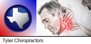 Tyler, Texas - male chiropractor massaging the neck of a patient