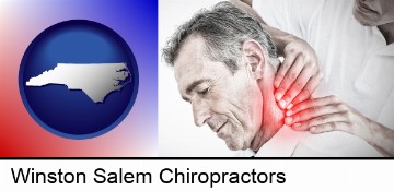 male chiropractor massaging the neck of a patient in Winston Salem, NC
