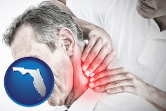 florida map icon and male chiropractor massaging the neck of a patient