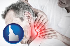 idaho map icon and male chiropractor massaging the neck of a patient