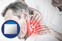 wyoming map icon and male chiropractor massaging the neck of a patient