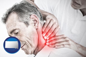 male chiropractor massaging the neck of a patient - with South Dakota icon