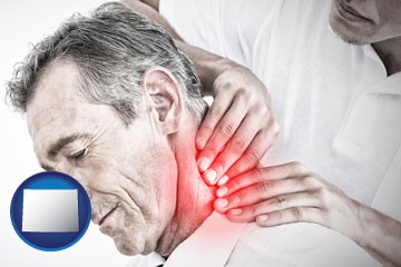 male chiropractor massaging the neck of a patient - with Wyoming icon