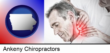 male chiropractor massaging the neck of a patient in Ankeny, IA