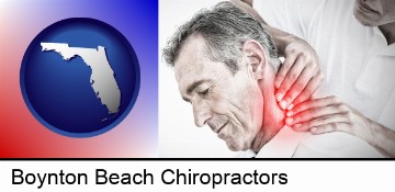 male chiropractor massaging the neck of a patient in Boynton Beach, FL