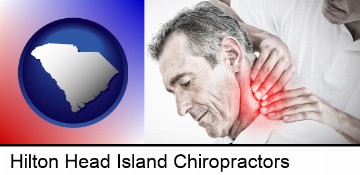 male chiropractor massaging the neck of a patient in Hilton Head Island, SC