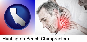 male chiropractor massaging the neck of a patient in Huntington Beach, CA