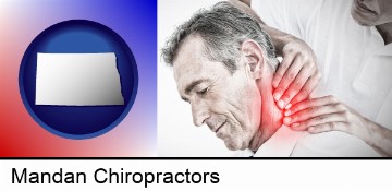 male chiropractor massaging the neck of a patient in Mandan, ND