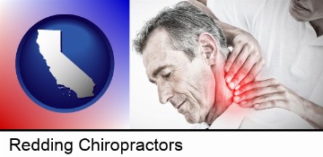 male chiropractor massaging the neck of a patient in Redding, CA