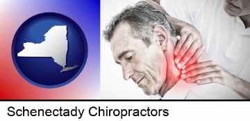 male chiropractor massaging the neck of a patient in Schenectady, NY