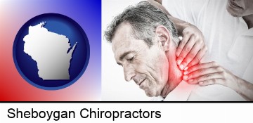 male chiropractor massaging the neck of a patient in Sheboygan, WI