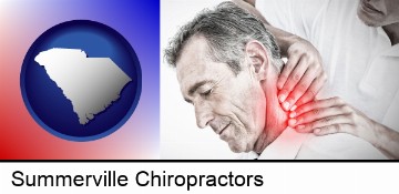 male chiropractor massaging the neck of a patient in Summerville, SC