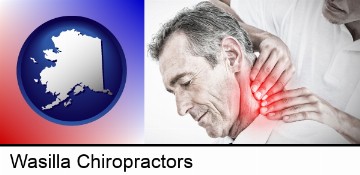 male chiropractor massaging the neck of a patient in Wasilla, AK